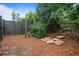 Secluded backyard featuring stone steps, a wooden fence and mature trees at 2490 Hillandale Cir, Cumming, GA 30041