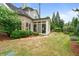 Well-manicured backyard featuring a sunroom, brick elevation, and lush landscaping at 2490 Hillandale Cir, Cumming, GA 30041