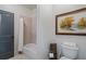 Bright bathroom featuring a tub with shower, toilet, and neutral color palette at 2490 Hillandale Cir, Cumming, GA 30041