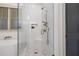 Bright, tiled bathroom features a modern glass shower and soaking tub with bronze fixtures at 2490 Hillandale Cir, Cumming, GA 30041