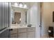 Well-lit bathroom features a large mirror, vanity with storage, and a neutral color palette at 2490 Hillandale Cir, Cumming, GA 30041