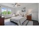 Comfortable bedroom with a queen bed, bedside tables, and a large window overlooking the backyard at 2490 Hillandale Cir, Cumming, GA 30041