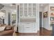 Elegant built-in bar area with glass cabinets, wine rack, and marble backsplash at 2490 Hillandale Cir, Cumming, GA 30041