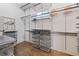 Walk-in closet with custom shelving, drawers, and hardwood flooring, offering ample storage space at 2490 Hillandale Cir, Cumming, GA 30041