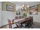 A dining room showcasing an elegant chandelier, decorative wall art, and a table set for a special occasion at 2490 Hillandale Cir, Cumming, GA 30041