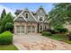 Charming two-story home featuring a beautiful stone driveway, lush landscaping, and an attached two-car garage at 2490 Hillandale Cir, Cumming, GA 30041