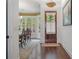 Elegant foyer showcasing hardwood floors, a wooden front door, and an arched doorway leading to the dining room at 2490 Hillandale Cir, Cumming, GA 30041