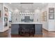 Modern kitchen showcasing a large island with seating, pendant lighting, and white cabinetry at 2490 Hillandale Cir, Cumming, GA 30041