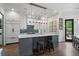 Stylish kitchen featuring an island, white cabinets, blue tile backsplash, and modern appliances at 2490 Hillandale Cir, Cumming, GA 30041
