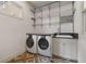 Well-lit laundry room features modern washer, dryer, utility sink, and ample storage at 2490 Hillandale Cir, Cumming, GA 30041