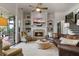 Bright living room features a stone fireplace, white trim, and a comfortable leather couch at 2490 Hillandale Cir, Cumming, GA 30041