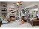 Cozy living room boasts a stone fireplace, built-in shelves, and a leather sectional at 2490 Hillandale Cir, Cumming, GA 30041
