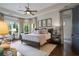 Spacious main bedroom with tray ceiling, large windows, and elegant decor at 2490 Hillandale Cir, Cumming, GA 30041