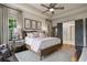 Elegant main bedroom with tray ceiling, hardwood floors, and ensuite bathroom access at 2490 Hillandale Cir, Cumming, GA 30041