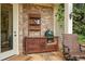 Outdoor kitchen with brick accents, built-in grill, and ample counter space, perfect for outdoor entertaining at 2490 Hillandale Cir, Cumming, GA 30041