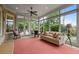 Cozy sunroom with large windows, brick accents, and views of the landscaped yard at 2490 Hillandale Cir, Cumming, GA 30041