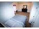 Bedroom with a calming color palette featuring a bed, dark dresser, and desk with a purple curtain window at 4041 Smithfield Trl, Ellenwood, GA 30294