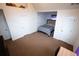 Spacious bedroom featuring neutral carpet, multiple doors, and a cozy bed with a gray comforter at 4041 Smithfield Trl, Ellenwood, GA 30294
