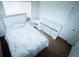 Well-lit bedroom with an embellished headboard on the bed and a matching dresser next to the door at 4041 Smithfield Trl, Ellenwood, GA 30294