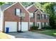 Charming two-story brick home with a well-maintained front yard and a two-car garage at 4041 Smithfield Trl, Ellenwood, GA 30294