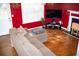 Comfortable living room with hardwood floors, a plush sectional sofa, and a decorative fireplace at 4041 Smithfield Trl, Ellenwood, GA 30294