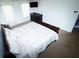 Bright main bedroom with two windows, a comfortable bed, a TV and neutral-colored carpet at 4041 Smithfield Trl, Ellenwood, GA 30294