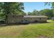 Spacious backyard featuring a brick house, a deck, a grill, and green grass at 4070 Lauada Dr, Douglasville, GA 30135