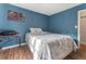 Bedroom features a full sized bed with hardwood floors and natural light from one window at 4070 Lauada Dr, Douglasville, GA 30135