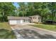 Home with attached garage, brick facade and long concrete driveway at 4070 Lauada Dr, Douglasville, GA 30135