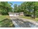 Home with attached garage, brick facade and long concrete driveway at 4070 Lauada Dr, Douglasville, GA 30135