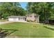 Charming two-story home with a brick facade, well-maintained lawn, and mature trees at 4070 Lauada Dr, Douglasville, GA 30135