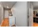 Hallway with wood floors and a white refrigerator near a door leading to a living space at 4070 Lauada Dr, Douglasville, GA 30135
