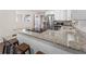 Kitchen featuring granite counters, white cabinets, stainless steel appliances, and countertop seating at 4070 Lauada Dr, Douglasville, GA 30135
