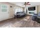 Well-lit living room featuring wood floors, modern entertainment center, and comfortable seating at 4070 Lauada Dr, Douglasville, GA 30135