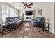 Bright living room with wood floors, large TV, and comfortable sofas at 4070 Lauada Dr, Douglasville, GA 30135