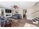 Spacious living room with wood floors, built-in entertainment center, and staircase at 4070 Lauada Dr, Douglasville, GA 30135