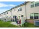 View of the backyard patio with lawn and two story siding of this townhome at 241 Irwell Path, Lawrenceville, GA 30044