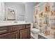 Bathroom featuring a single vanity, toilet, and a shower with beach-themed shower curtain at 241 Irwell Path, Lawrenceville, GA 30044