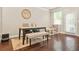 Bright dining area with a modern table, chairs, bench seating, and natural light from the windows and door at 241 Irwell Path, Lawrenceville, GA 30044