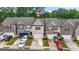 Charming exterior view of several townhomes, each with a private garage at 241 Irwell Path, Lawrenceville, GA 30044