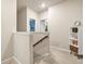 Upstairs hallway featuring carpet flooring, neutral paint, and a view into adjacent rooms with plenty of light at 241 Irwell Path, Lawrenceville, GA 30044