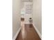 Hallway featuring hardwood floors, a picture frame, and trim throughout at 241 Irwell Path, Lawrenceville, GA 30044