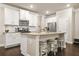 Island kitchen with white cabinets, granite countertops, and stainless appliances at 241 Irwell Path, Lawrenceville, GA 30044