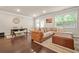 Spacious living room with dark hardwood floors, a large couch, and lots of light at 241 Irwell Path, Lawrenceville, GA 30044