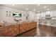 Open-concept living room featuring a large comfortable sofa, modern decor, and seamlessly connected kitchen area at 241 Irwell Path, Lawrenceville, GA 30044