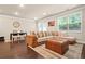 Spacious living room with dark hardwood floors, a large couch, and lots of light at 241 Irwell Path, Lawrenceville, GA 30044