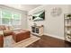 Cozy living room with a comfortable sofa, stylish ottoman, modern entertainment center, and bright natural light at 241 Irwell Path, Lawrenceville, GA 30044