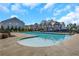 Community pool with inviting blue water and surrounding houses on a sunny day at 241 Irwell Path, Lawrenceville, GA 30044