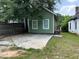 View of backyard featuring a green house with a concrete patio and partially fenced yard at 490 Rockwell Sw St, Atlanta, GA 30310