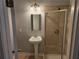 Cozy bathroom featuring a pedestal sink, tile surround, and shower with a glass enclosure at 490 Rockwell Sw St, Atlanta, GA 30310